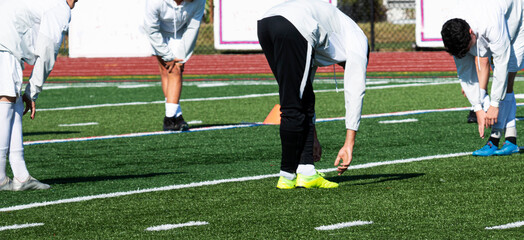 Soccer players stretching before a game