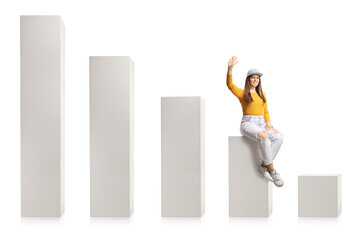 Young trendy female sitting on a graph chart and waving at camera