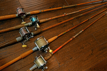 Vintage bamboo fishing rods and conventional reels - 414257513