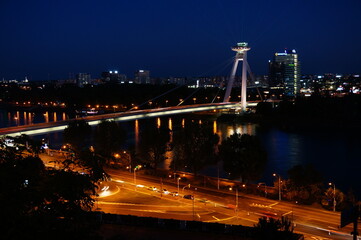 Fototapeta na wymiar UFO tower and Bridge SNP over Danube river in Slovak capital city Bratislava at night