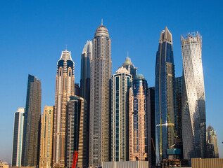 Obraz na płótnie Canvas Dubai,UAE - 02.14.2021 View of a towers in Dubai Marina district. Outdoors