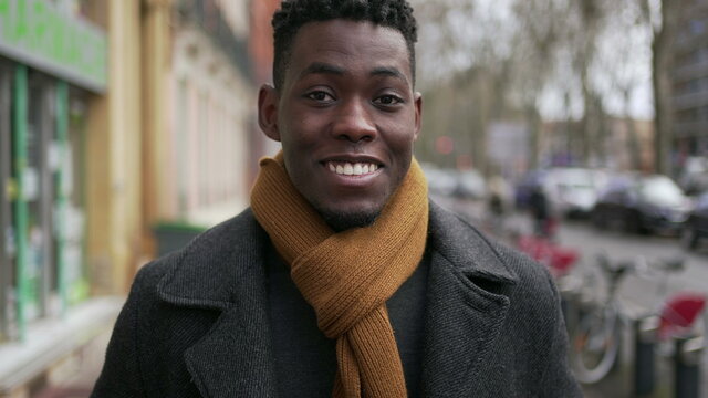 Young handsome black African man portrait looking at camera wearing winter clothing