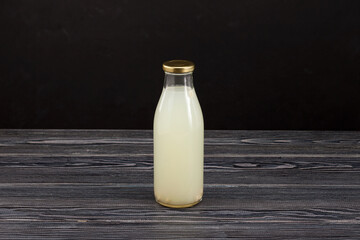 Rejuvelac or home made water kefir in glass bottle. Healthy fermented drink. Natural probiotic made by soaking sprouted grains