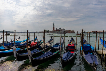 Fototapeta na wymiar Gondolas parked on a pier in Venice Italy.