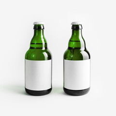Two green beer bottles with blank labels. Responsive design mockup.