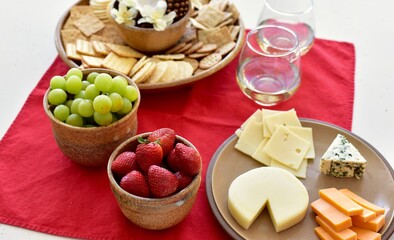 Gourmet wine and cheese charcuterie platter ordering out from restaurant for romantic date night at home on special occasion holiday or birthday. Photo concept, food lifestyle, background, close-up