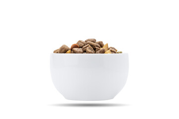 domestic animals dry food at white bowl isolated on white background. dried cat feed cut out. above view