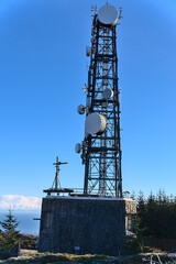 Fototapeta na wymiar Three Rock TV transmitter antenna viewed from Fairy Castle (Two Rock Mountain), Dublin Mountains, Ireland. Single cellular tower top in against clear blue sky. Vertical view