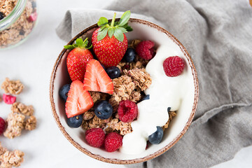 Breakfast cereal with berries in a white bowl