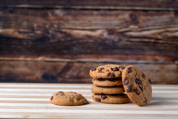 Chocochips cookies with wood background and red cup
