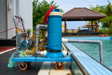 Fototapeta na wymiar A filter pump cleans the pool water. Device for automatic cleaning of swimming pools