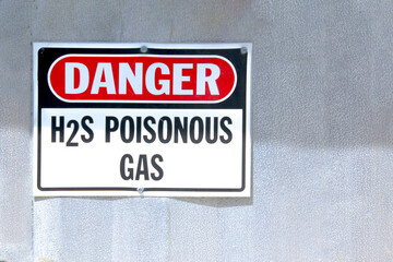 A Danger H2S Poisonous Gas sign on a Natural Gas facility. - obrazy, fototapety, plakaty