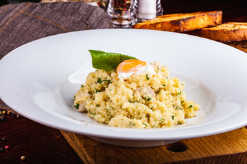 Couscous with chicken and egg on a white plate