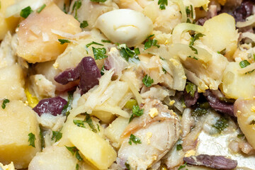 dish known as codfish food, containing codfish, onion, egg, potato and black olives
