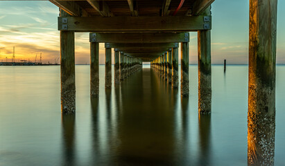 Under a pier View at sunset at Fairhope, Alabama.