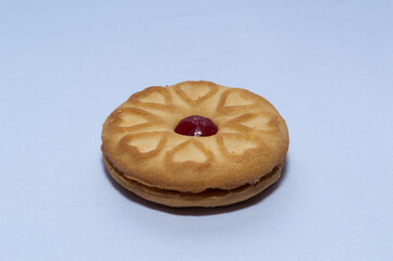 Red centered jam biscuits with a strawberry flavor and on a plain white background