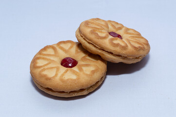 Red centered jam biscuits with a strawberry flavor and on a plain white background