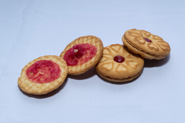 Red centered jam biscuits with a strawberry flavor and on a plain white background