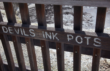 Devils Ink Pots sign in Wai-O-Tapu Thermal Wonderland in Rotorua, New Zealand.