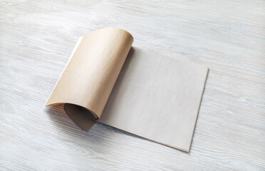Blank magazine template on wood table background. Responsive design mockup.