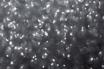 abstract silver background bokeh. sparkles of silver glitter. elegant silver backdrop.