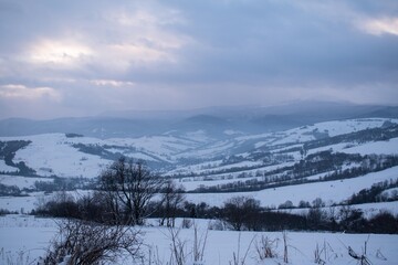 Fototapeta na wymiar Winter in the mountains. Panorama, evening sky, clouds. 