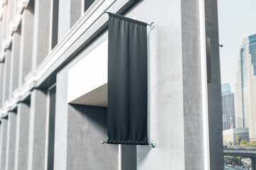 Blank black fabric signboard in front of entrance to modern business center. Mockup