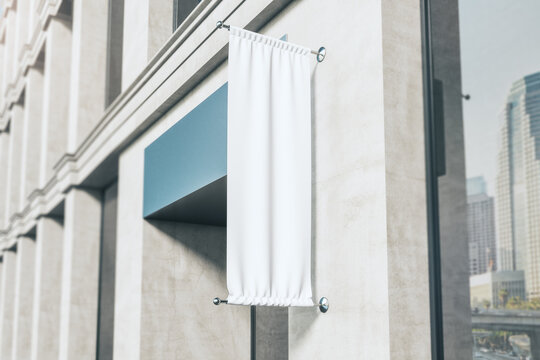 Blank white fabric advertising roll up on modern building wall in the morning. Mockup