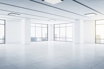 Modern spacious empty light hall room with big windows, ceramic tiles on the floor and lights on top