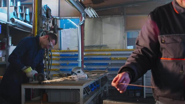 Welder working with autogenous welding tool in workshop