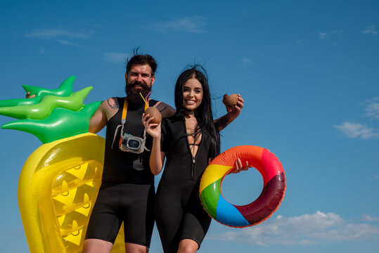 Summer couple vacation at beach. Sexy woman in bikini. Summertime concept. Sexy man in swimsuit. Surfboard.