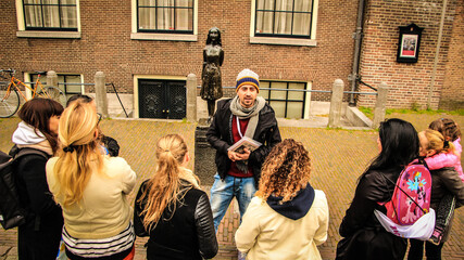 TOUR GUIDE WITH A GROUP OF PEOPLE