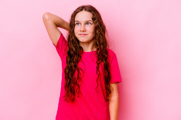 Little caucasian girl isolated on pink background suffering neck pain due to sedentary lifestyle.