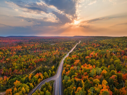 Sunset Autumn drive through the tunnel of Trees in Michigan Upper Peninsula UP - Highway 41  M26 Aerial view