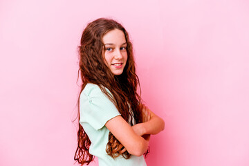 Little caucasian girl isolated on pink background laughing and having fun.
