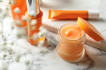 Set of luxury cosmetic products on white marble table