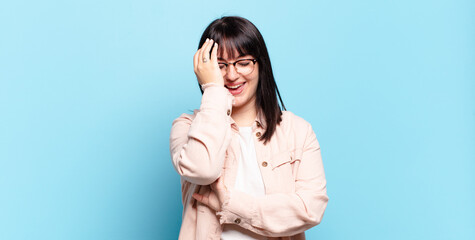 plus size pretty woman laughing and slapping forehead like saying d’oh! I forgot or that was a...