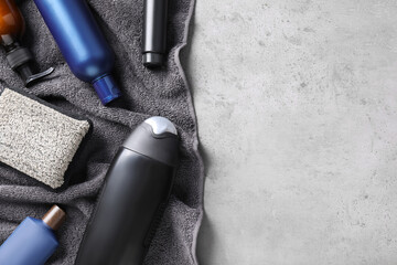 Flat lay composition with men's cosmetics on light grey stone background. Space for text