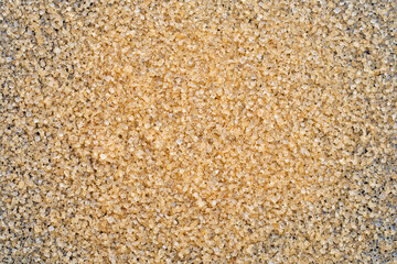 Brown sugar on dark background.