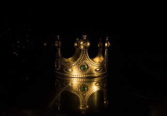 low key image of beautiful queen/king crown over wooden table. vintage filtered. fantasy medieval...