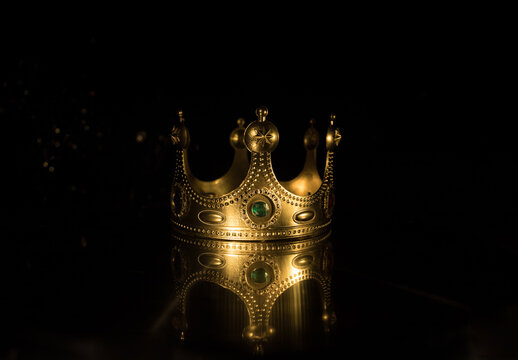 low key image of beautiful queen/king crown over wooden table. vintage filtered. fantasy medieval period