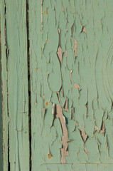 green peeling paint on wooden door