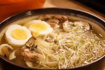 Ramen with boiled eggs, sprouts, and mushrooms