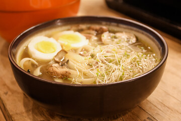 Ramen with boiled eggs, sprouts, and mushrooms