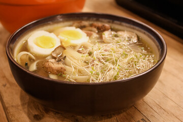 Ramen with boiled eggs, sprouts, and mushrooms