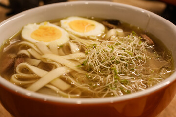 Ramen with boiled eggs, sprouts, and mushrooms