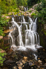 Fototapeta na wymiar Upper Sunbeam Falls cascading in Mount Rainier National Park adjacent to the Stevens Canyon Road and readily viewable by tourists