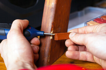 restoration repair wood surface on furniture sealing scratches and chips set of tools close-up