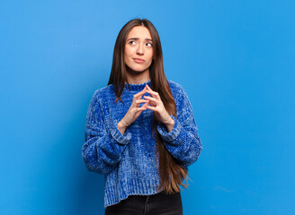 young pretty casual woman scheming and conspiring, thinking devious tricks and cheats, cunning and...
