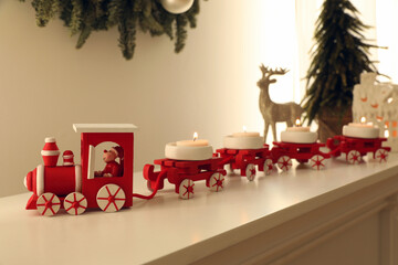 Obraz na płótnie Canvas Red toy train as Christmas candle holder on shelf